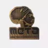 Gold pin of meta and the cornerstones logo